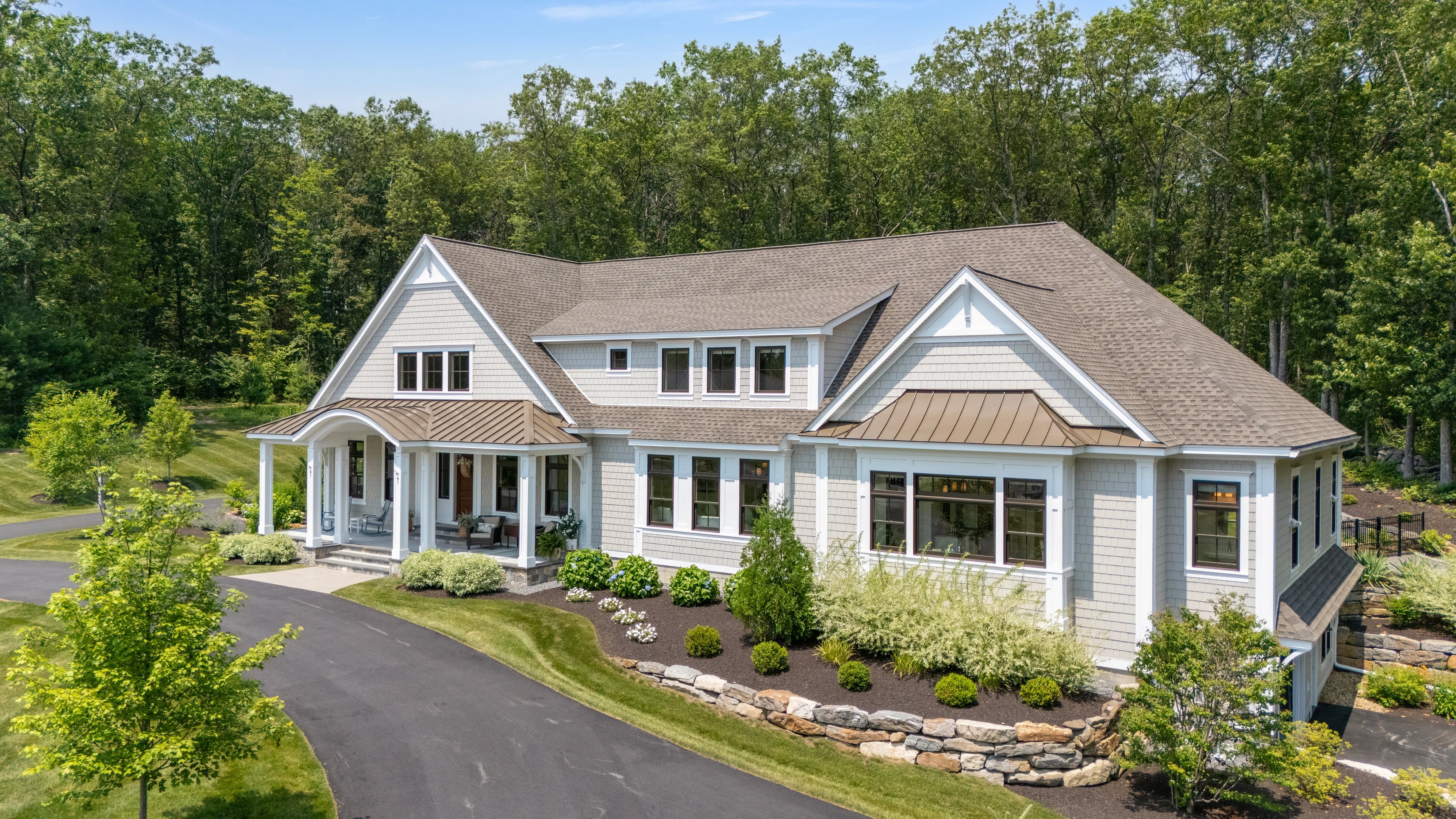 Aerial view of a shingle-style New England home and grounds