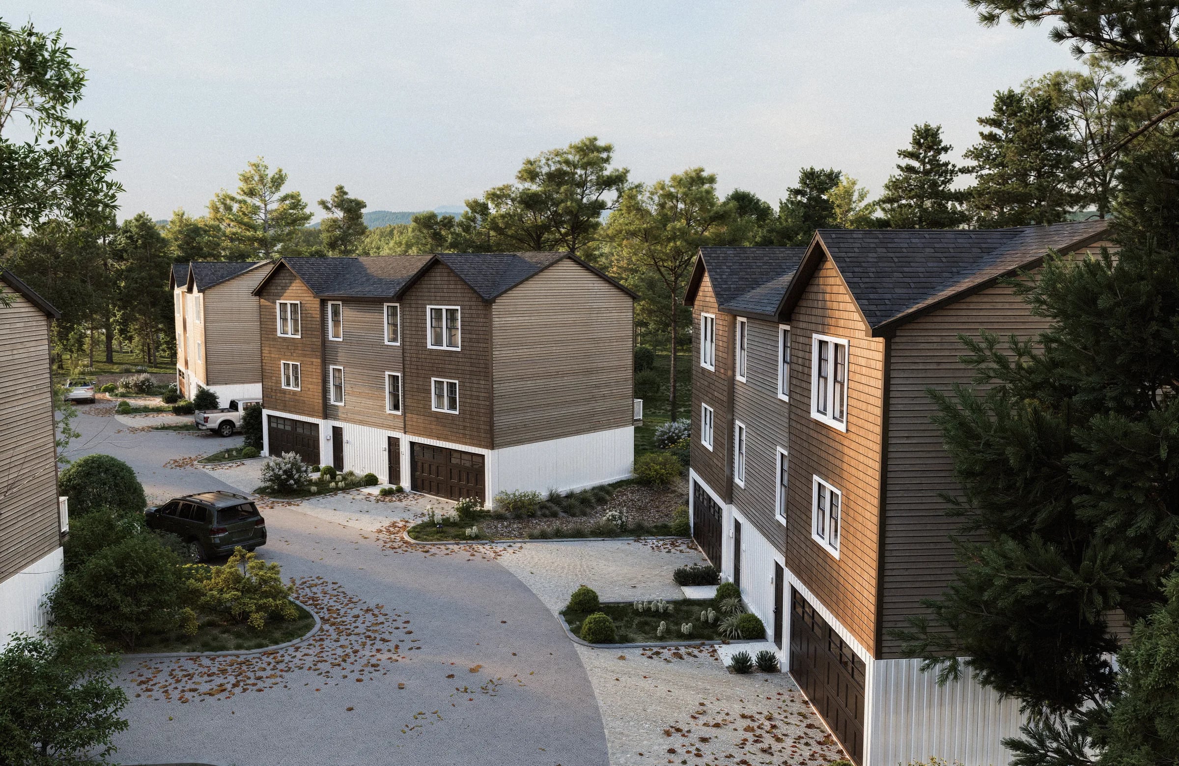 3D rendering of an aerial view over a townhome development, the buildings stepping down a wooded drive